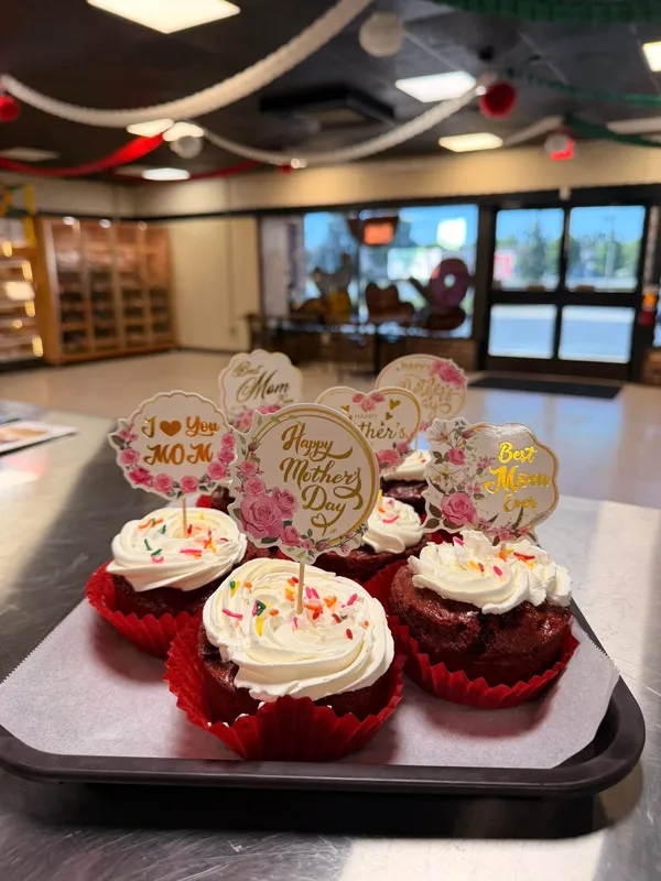 Red velvet Mother's Day cupcakes with festive red icing and toppers