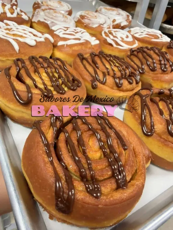 Sweet rolls decorated with chocolate icing drizzle