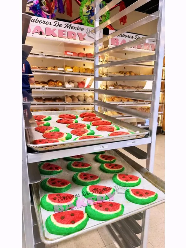 Interior display shelves stocked with fresh Mexican pan dulce and watermelon cookies