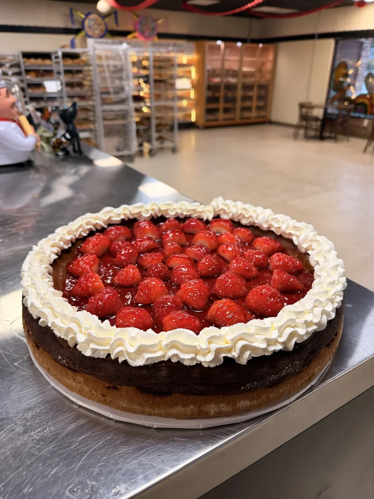 Fresh strawberry chocoflan cake with glazed strawberries and whipped cream