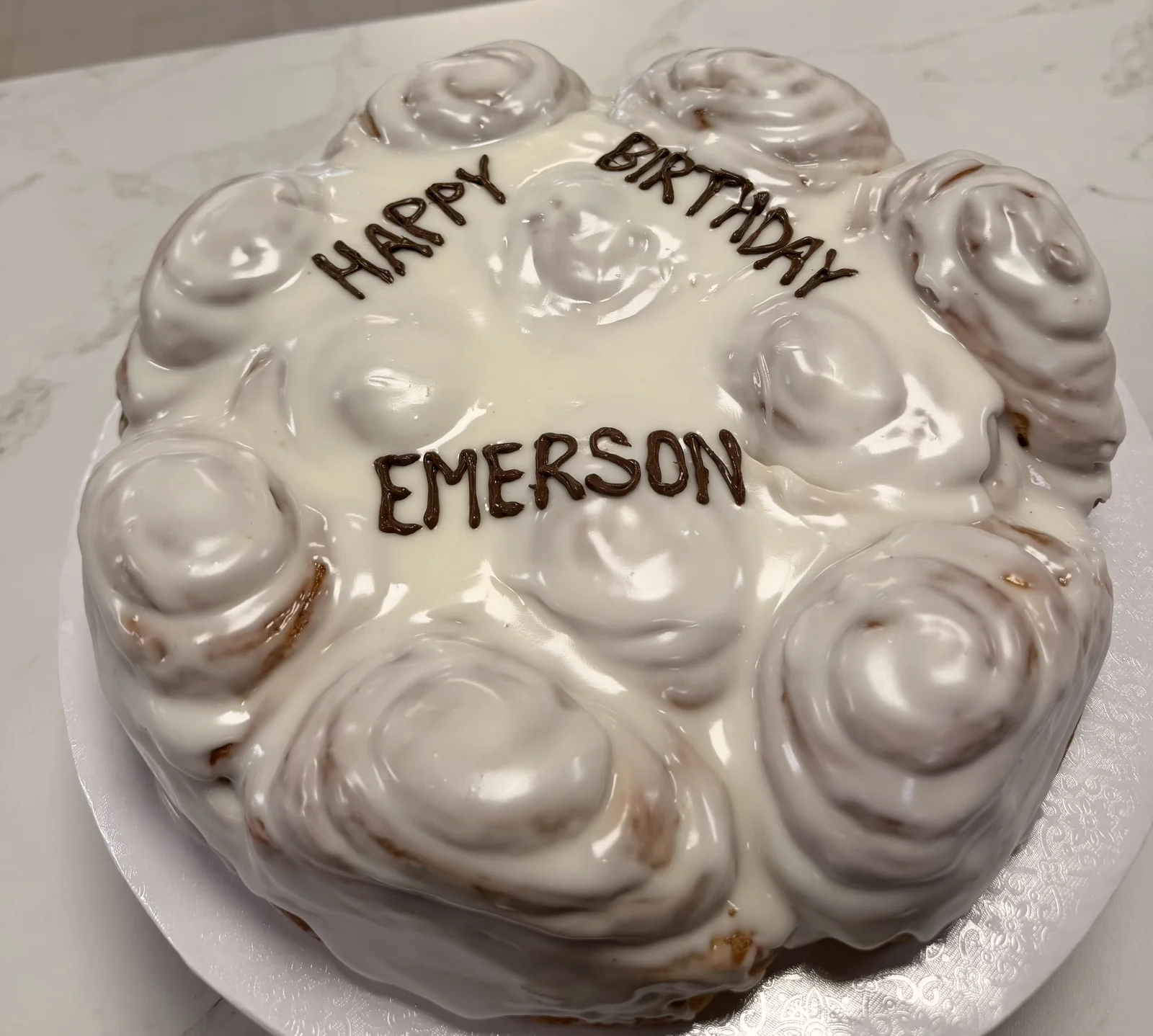 Cinnamon roll celebration birthday cake platter with Happy Birthday Emerson chocolate lettering