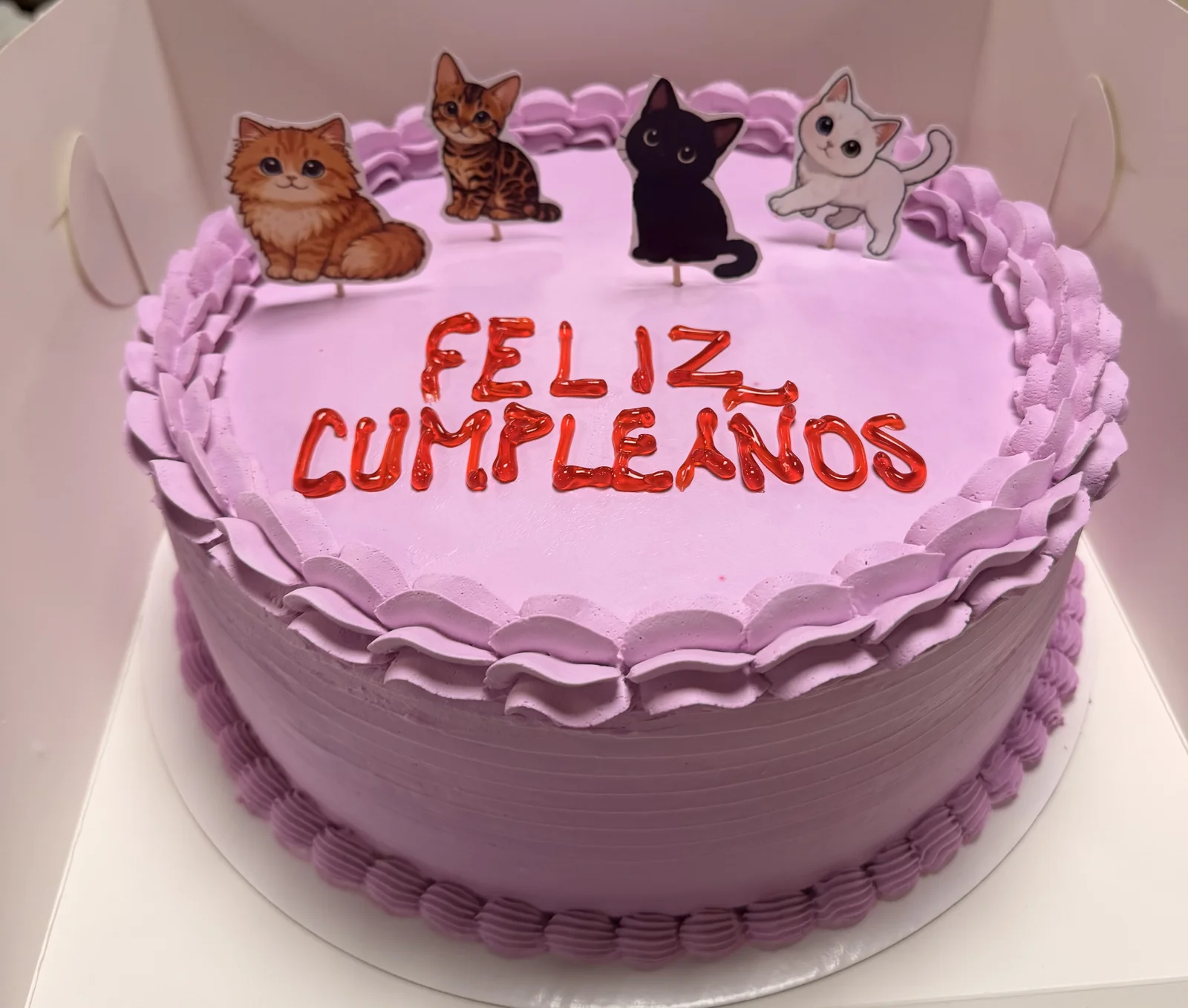 Lavender kitten themed birthday cake with cute illustrated kittens and Feliz Cumpleaños greeting